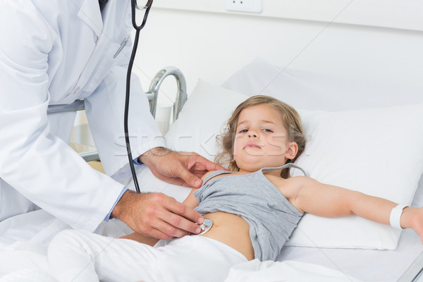 Doctor examining stomach of sick girl Stock photo © wavebreak_media