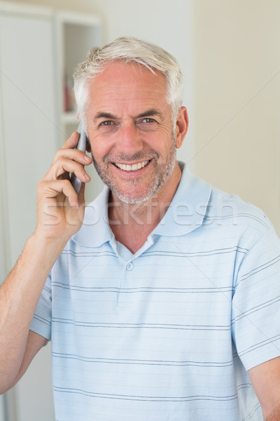 Smiling man on a phone call looking at camera Stock photo © wavebreak_media