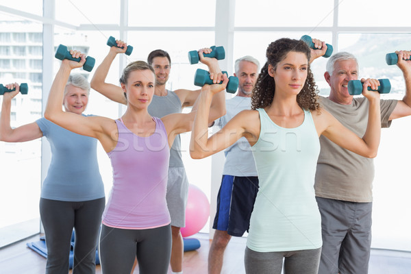 Class exercising with dumbbells in gym Stock photo © wavebreak_media