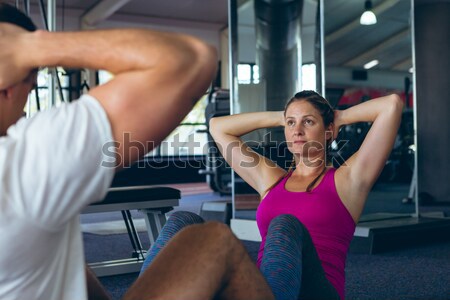Fit brunette using weights machine for arms Stock photo © wavebreak_media