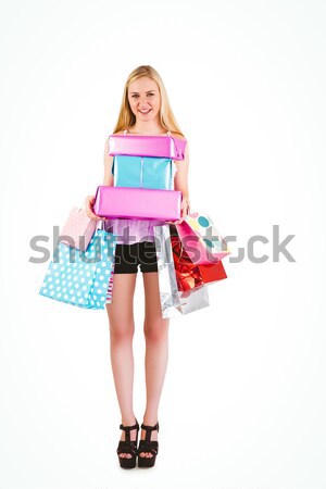 Pretty young blonde holding shopping bags Stock photo © wavebreak_media