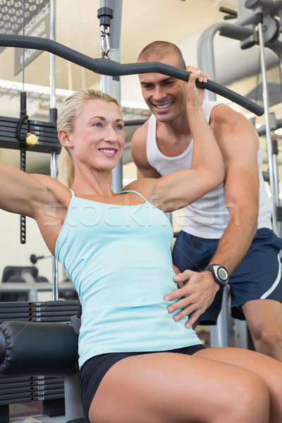 Male trainer assisting woman on a lat machine in gym Stock photo © wavebreak_media