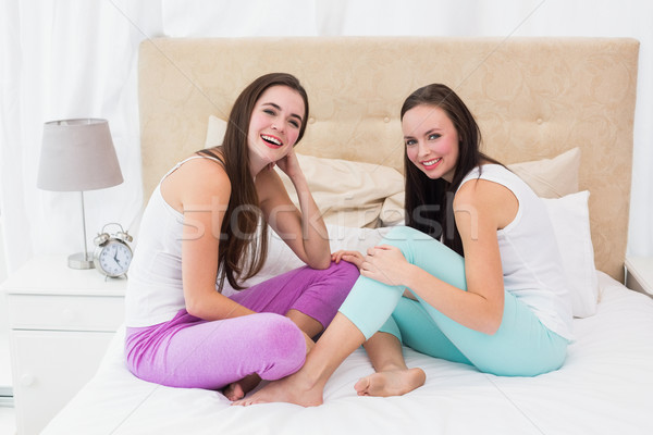 Pretty friends messing about on bed Stock photo © wavebreak_media