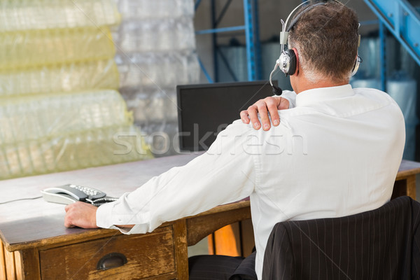Stock photo: Rear view of warehouse manager using computer