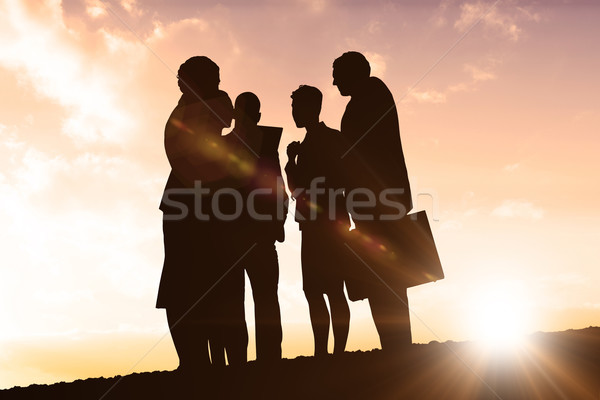 Composite image of silhouettes standing Stock photo © wavebreak_media
