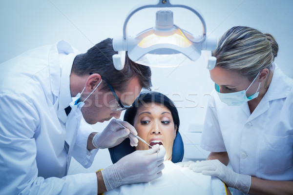 Dentist with assistant examining womans teeth Stock photo © wavebreak_media