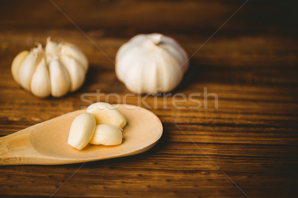 Garlic cloves and bulb on chopping board Stock photo © wavebreak_media