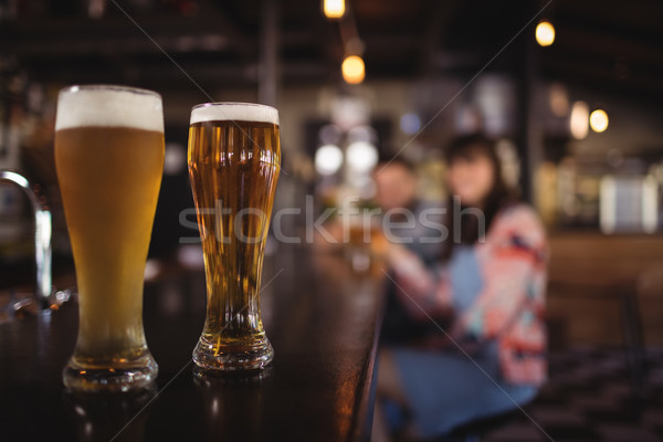 Two beer glasses on worktop Stock photo © wavebreak_media