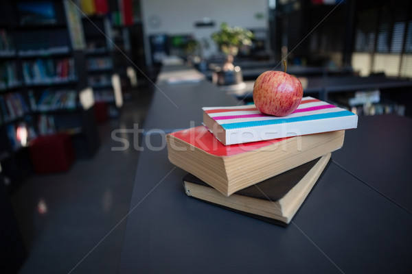 Apple on stack of books in liabrary Stock photo © wavebreak_media