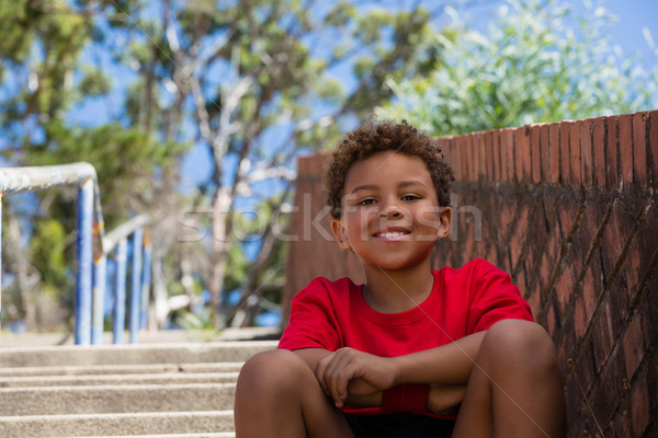 Boy sitting on staircase in the boot camp on a sunny day Stock photo © wavebreak_media