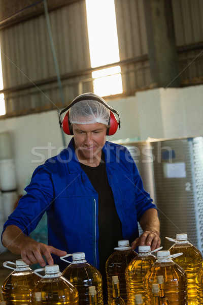 Worker checking a can of olives oil in factory Stock photo © wavebreak_media