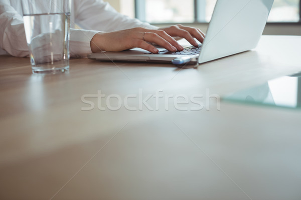 Mid section of businesswoman working on laptop Stock photo © wavebreak_media
