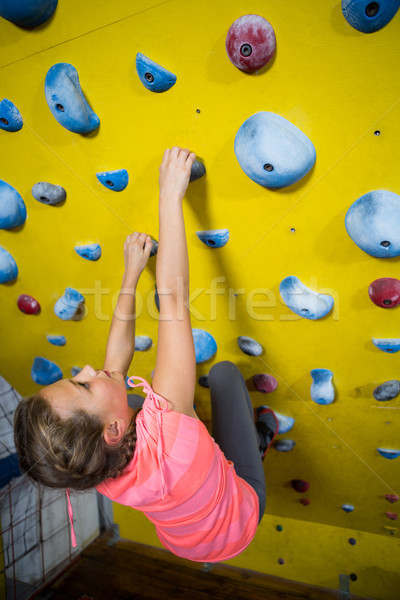 Teenage girl practicing rock climbing Stock photo © wavebreak_media