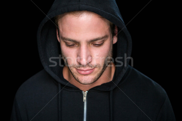 Handsome man wearing a black hoodie Stock photo © wavebreak_media