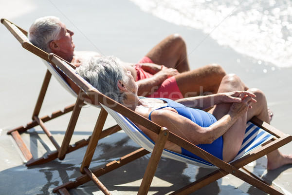 Cute mature couple lying on deckchairs Stock photo © wavebreak_media