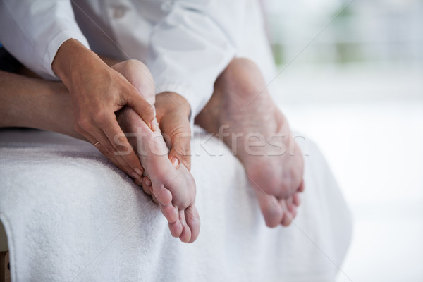 Senior man receiving foot massage from physiotherapist Stock photo © wavebreak_media