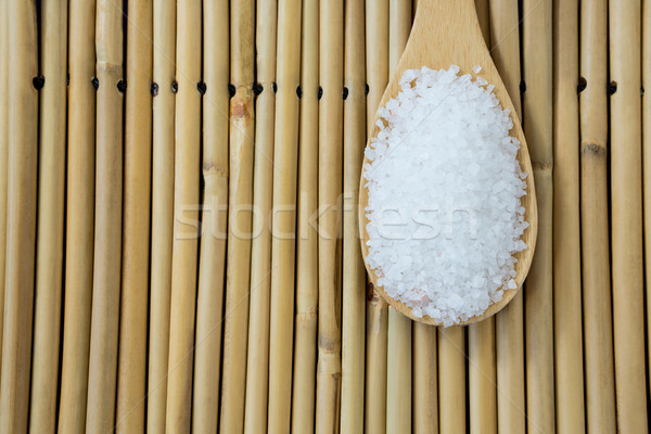 Salt in wooden scoop kept on bamboo mat Stock photo © wavebreak_media