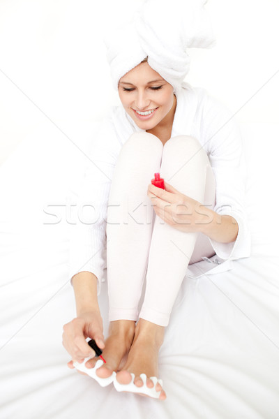 Jolly woman putting nail polish on her nails Stock photo © wavebreak_media