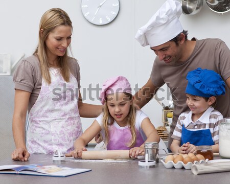 Mother and father helping children baking in the kitchen Stock photo © wavebreak_media