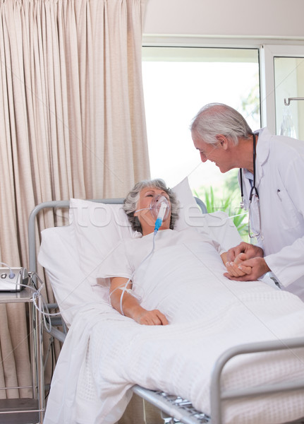 Stock photo: Senior doctor with his sick patient