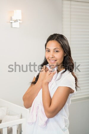 Good looking brunette woman awaking while sitting on a bed Stock photo © wavebreak_media