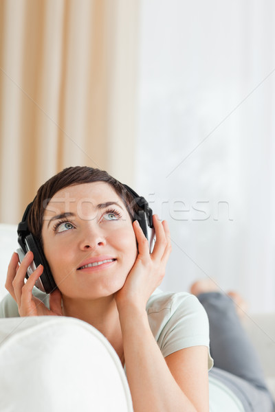 Portrait of a short-haired woman listening to music looking up Stock photo © wavebreak_media