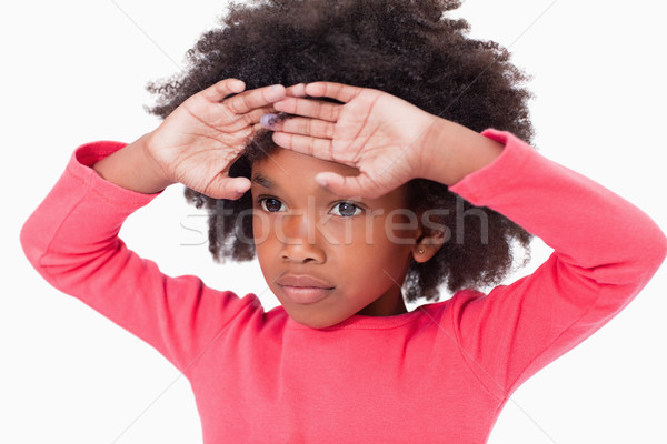 Cute girl with her hands on her forehead against a white background Stock photo © wavebreak_media