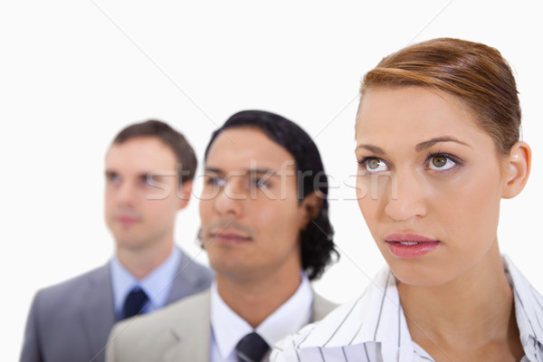 Businessteam standing in a row looking right against a white background Stock photo © wavebreak_media