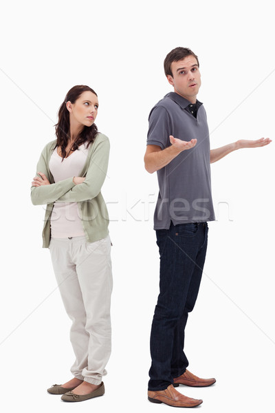 Man shrugged his shoulders back to back with angry woman against white background Stock photo © wavebreak_media