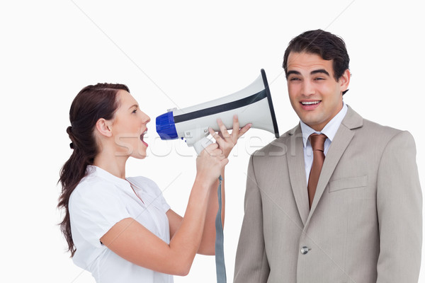 Saleswoman with megaphone yelling at colleague against a white background Stock photo © wavebreak_media