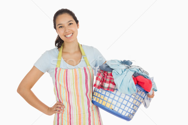 Feliz mulher avental completo cesto de roupa suja Foto stock © wavebreak_media