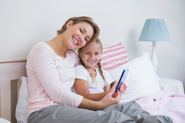 Stock photo: Mother and daughter using tablet pc