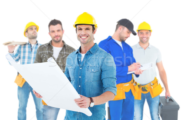 Composite image of happy architect holding blueprint in house Stock photo © wavebreak_media