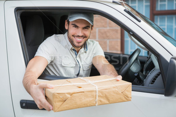 Delivery driver offering parcel from his van Stock photo © wavebreak_media