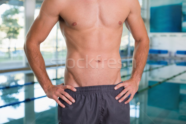 Mid section of a shirtless fit swimmer by pool at leisure center Stock photo © wavebreak_media