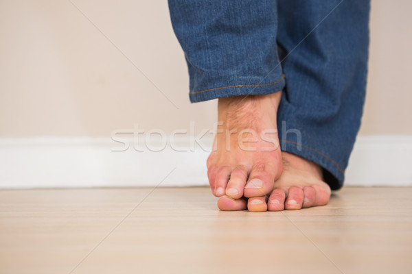 Mans bare feet on wooden floor Stock photo © wavebreak_media