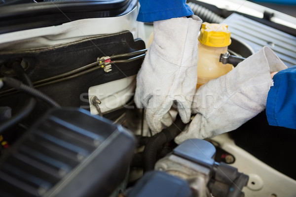 Stock photo: Mechanic working under the hood 