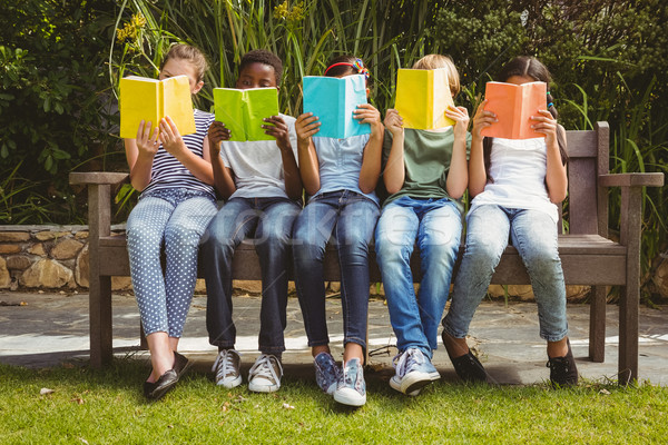 Children reading books at park Stock photo © wavebreak_media