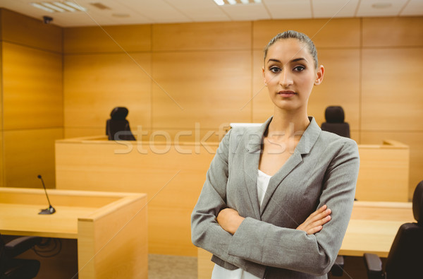 Unsmiling lawyer looking at camera crossed arms  Stock photo © wavebreak_media