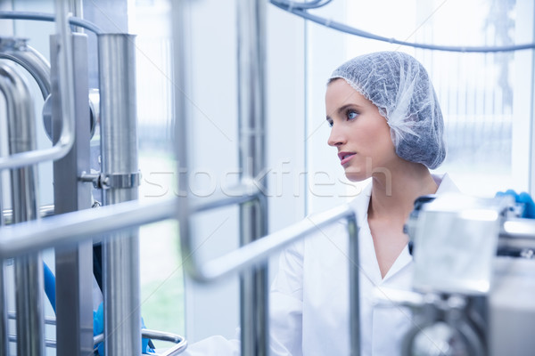 Portrait of a smiling scientist behind metal pipe Stock photo © wavebreak_media