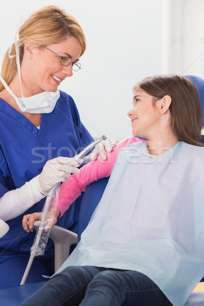 Smiling pediatric dentist reassuring her young patient Stock photo © wavebreak_media