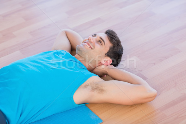 Smiling man lying on exercise mat  Stock photo © wavebreak_media