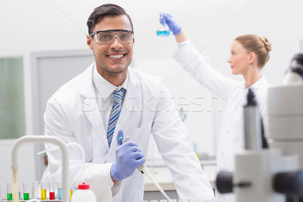 Scientists examining tubes and baker   Stock photo © wavebreak_media