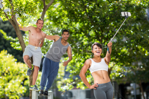 Smiling extreme athletes taking selfies with selfiestick  Stock photo © wavebreak_media