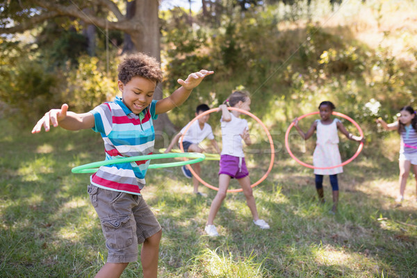 Group of friends enjoying with hula hoops at campsite Stock photo © wavebreak_media