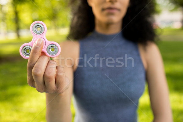 Girl holding a fidget spinner in a park Stock photo © wavebreak_media