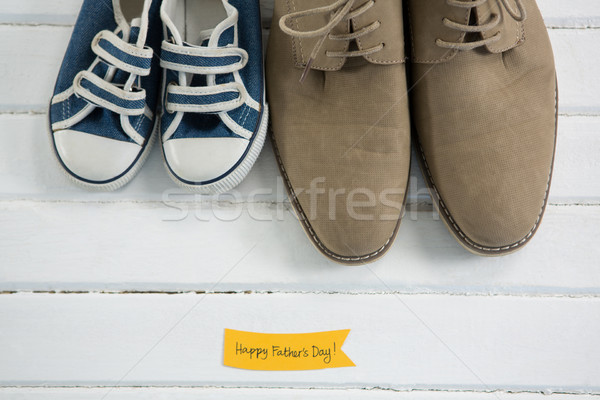 Overhead view of shoes by text on table Stock photo © wavebreak_media