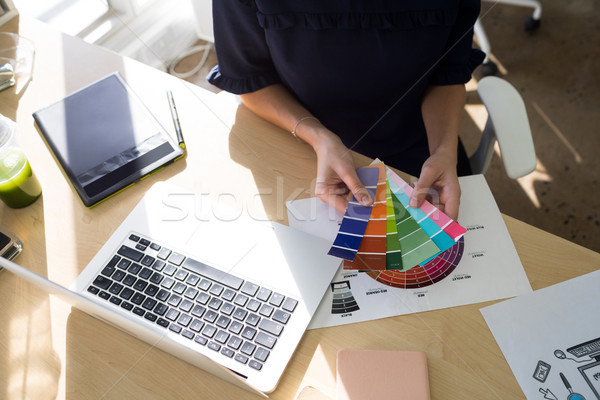 Female executives holding color shade swatch at her desk Stock photo © wavebreak_media