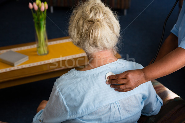 Hand of nurse examining patient in retirement home Stock photo © wavebreak_media