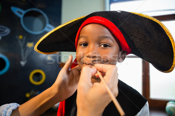 Hand of woman drawing mustache on boy face Stock photo © wavebreak_media